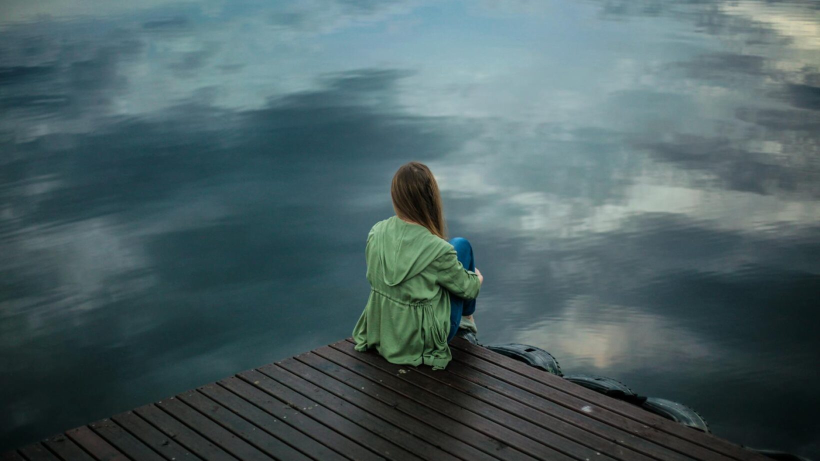 woman sitting on wooden planks